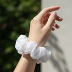 Close-up view of white mesh hair scrunchie made of soft stretchable material