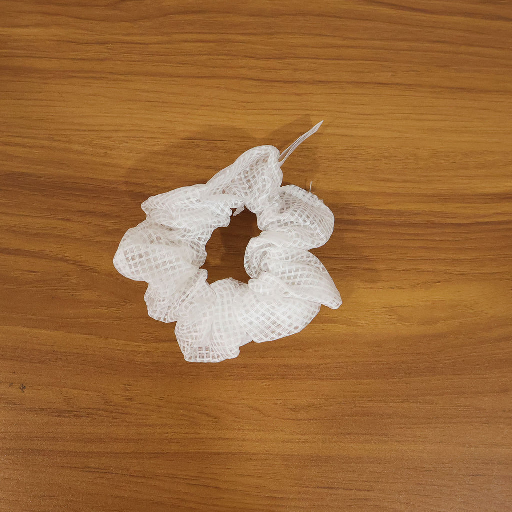 Model showcasing elegant white mesh hair scrunchie in styled ponytail