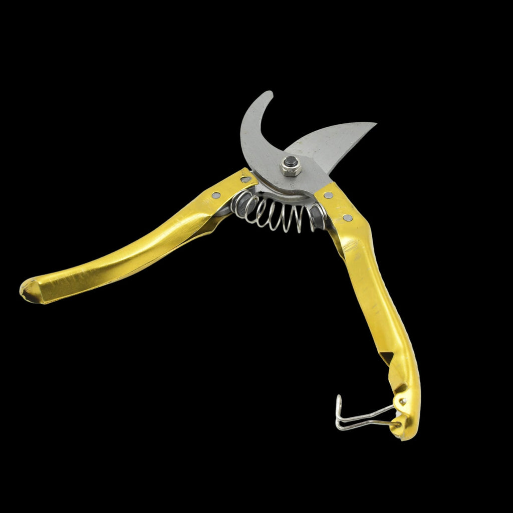 Detailed shot of the sharp gardening secateurs making a clean cut on a small branch.