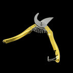 Detailed shot of the sharp gardening secateurs making a clean cut on a small branch.