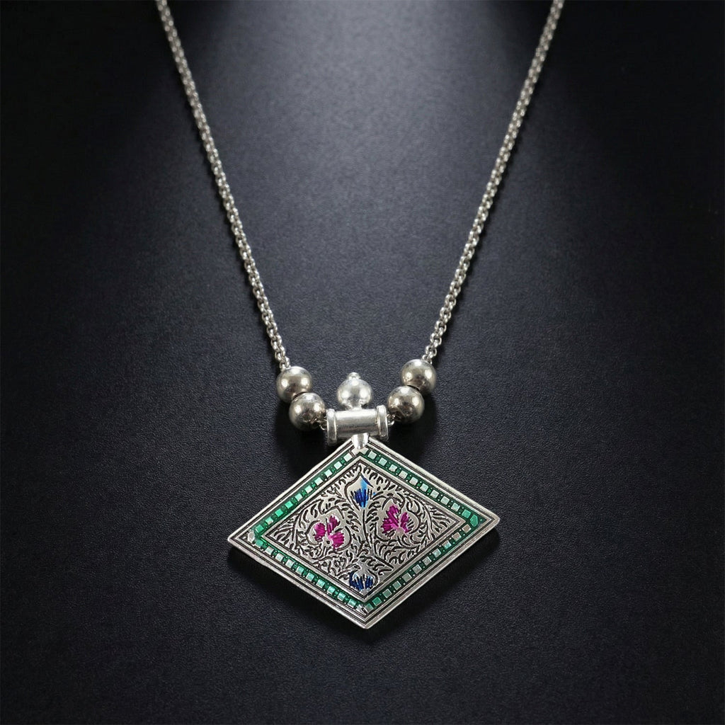 Ethnic oxidised silver finish pendant necklace displayed on white background
