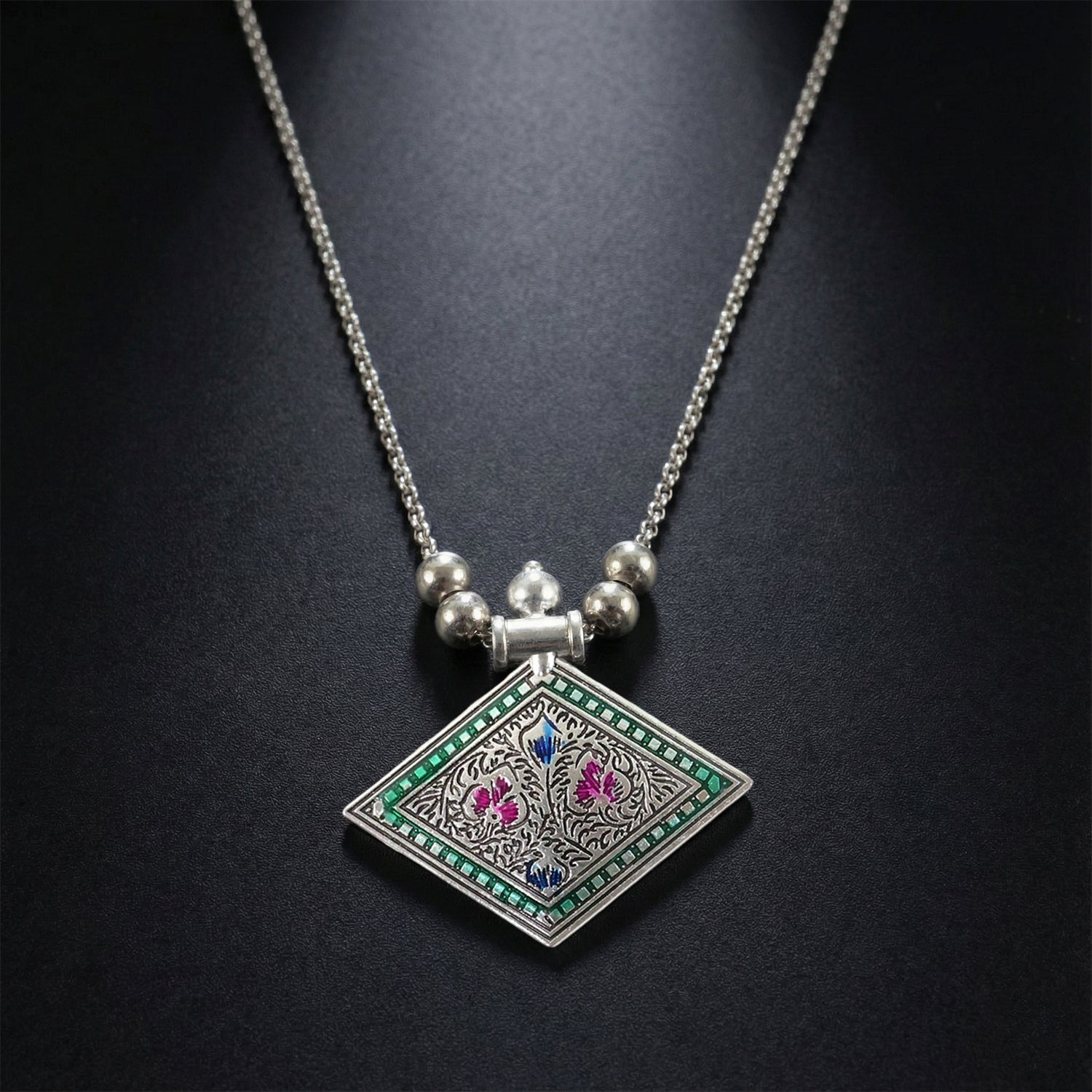 Ethnic oxidised silver finish pendant necklace displayed on white background