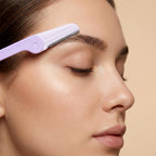 Close-up of precision eyebrow shaping razor with replaceable blades