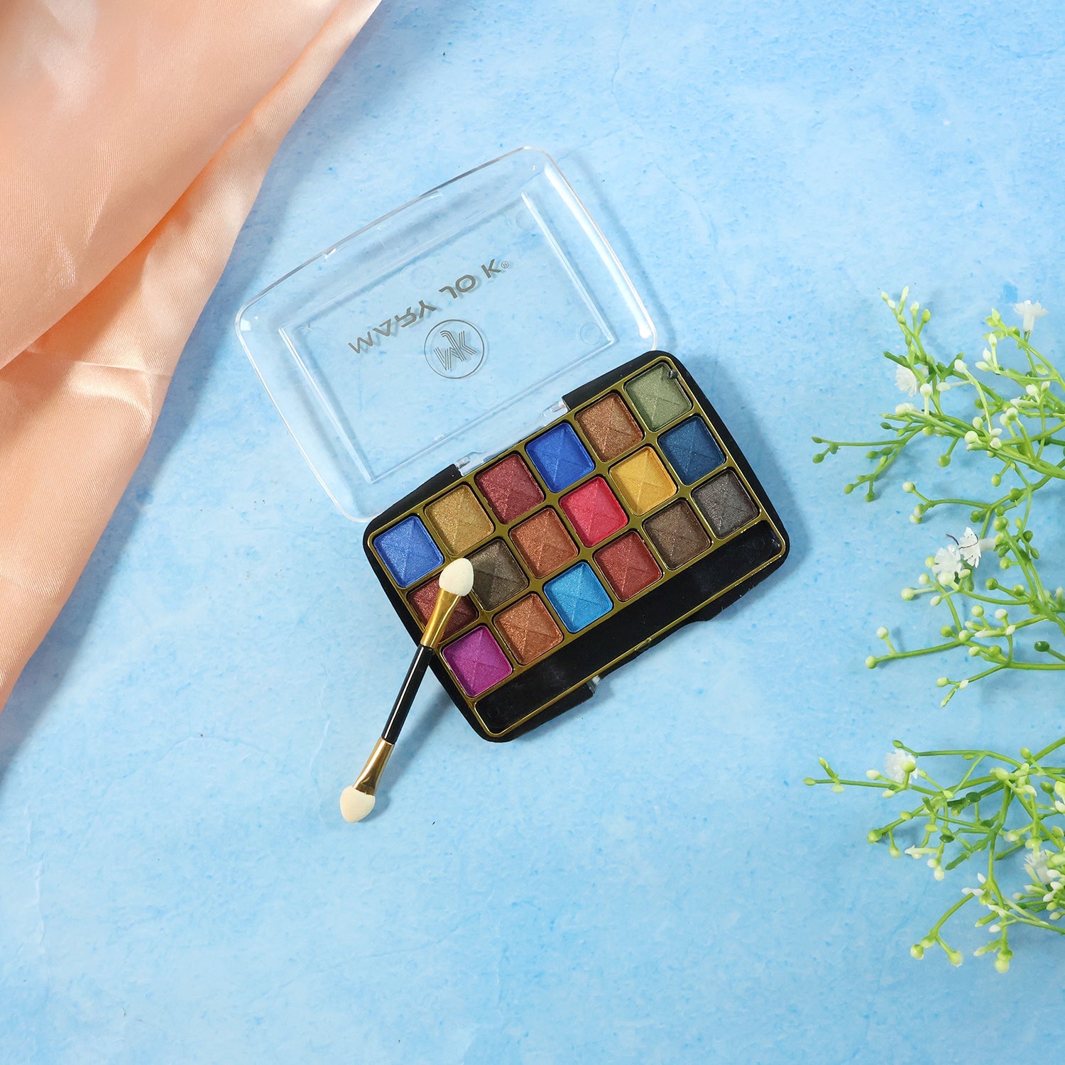 Close-up view of pink and purple shimmer eyeshadow shades in the palette