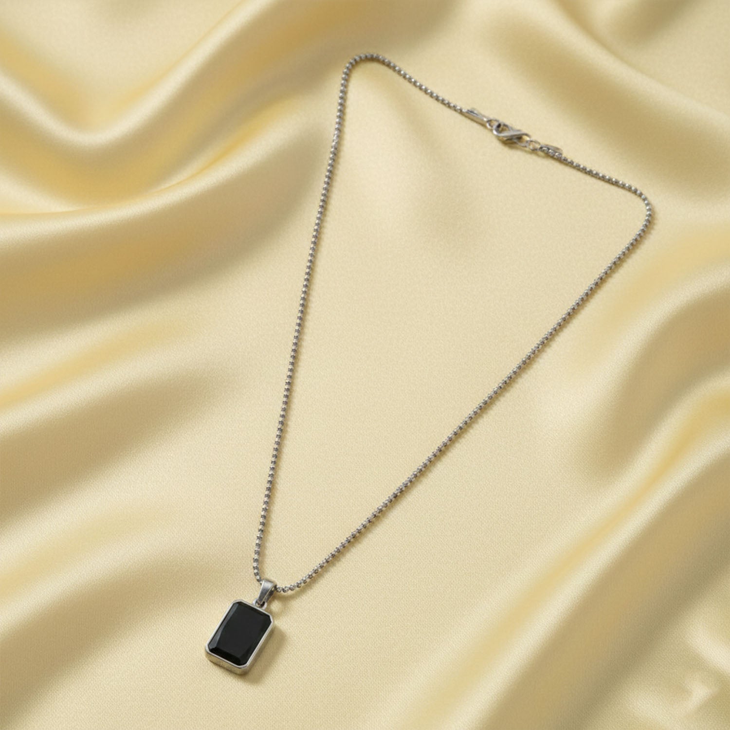 Side view of men's durable stainless-steel pendant chain with black pendant