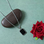 Fashionable men's pendant chain with black rectangle pendant on white background