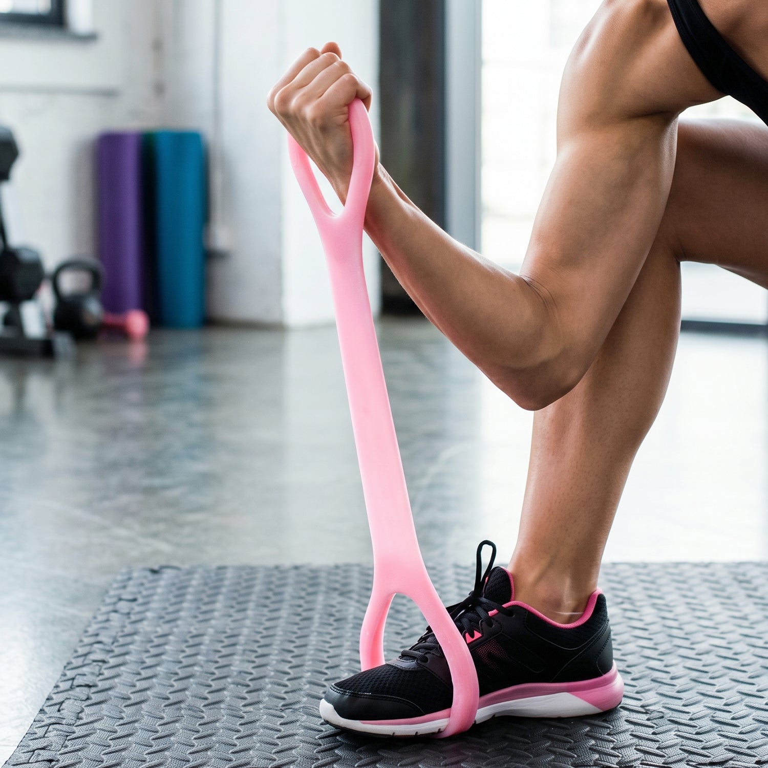 Pink silicone resistance band used for stretching exercises