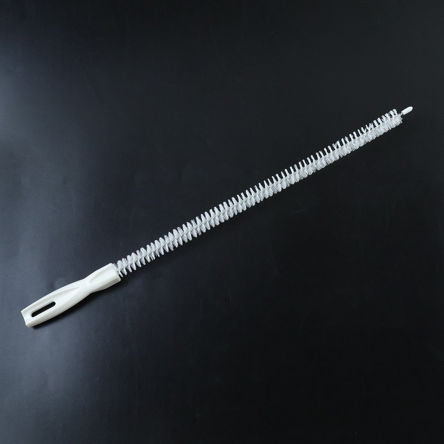Flexible long brush cleaning a kitchen sink drain
