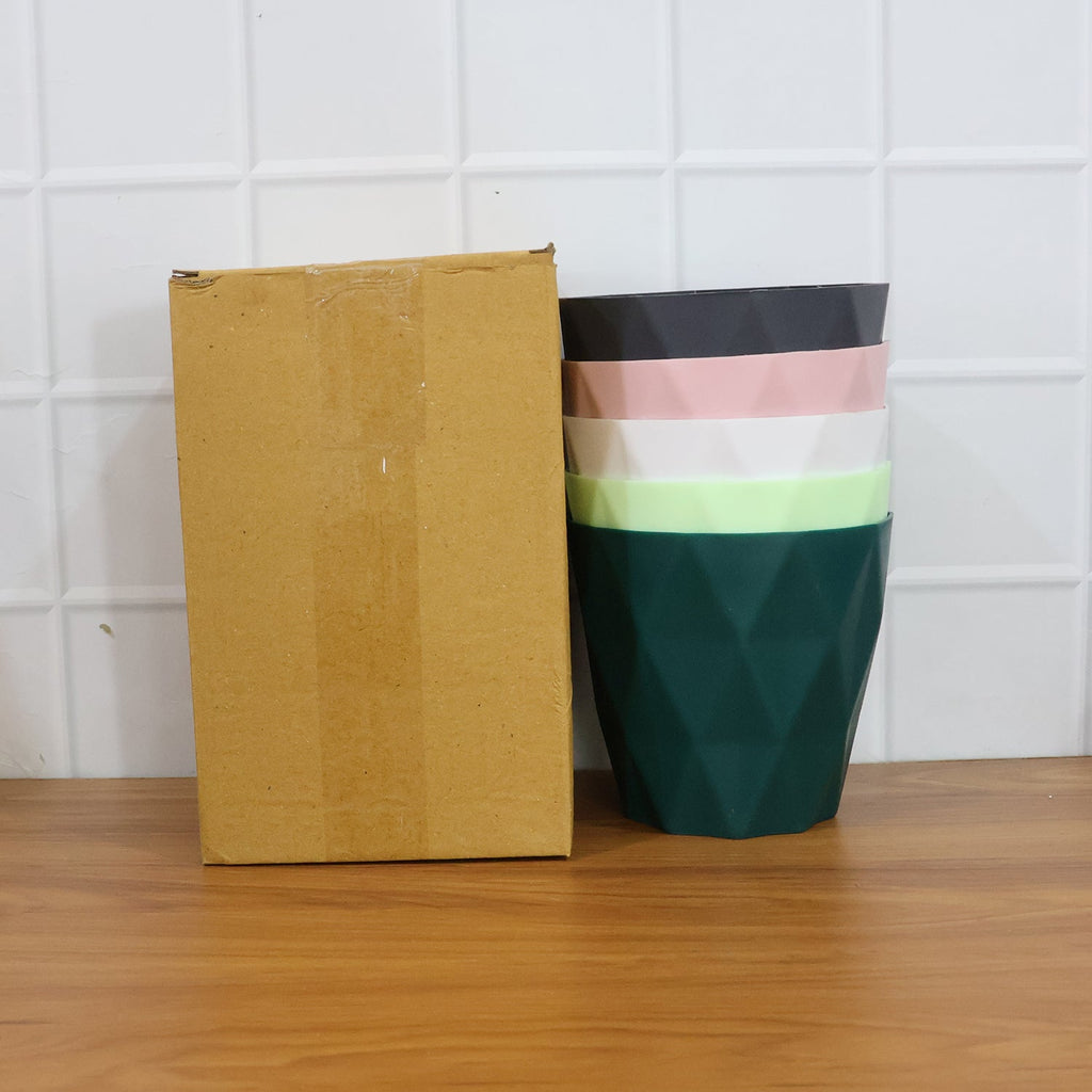 Diamond design flower pot set arranged on garden table with plants