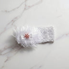 Floral baby headband displayed on a white background, highlighting soft elastic material and floral bow