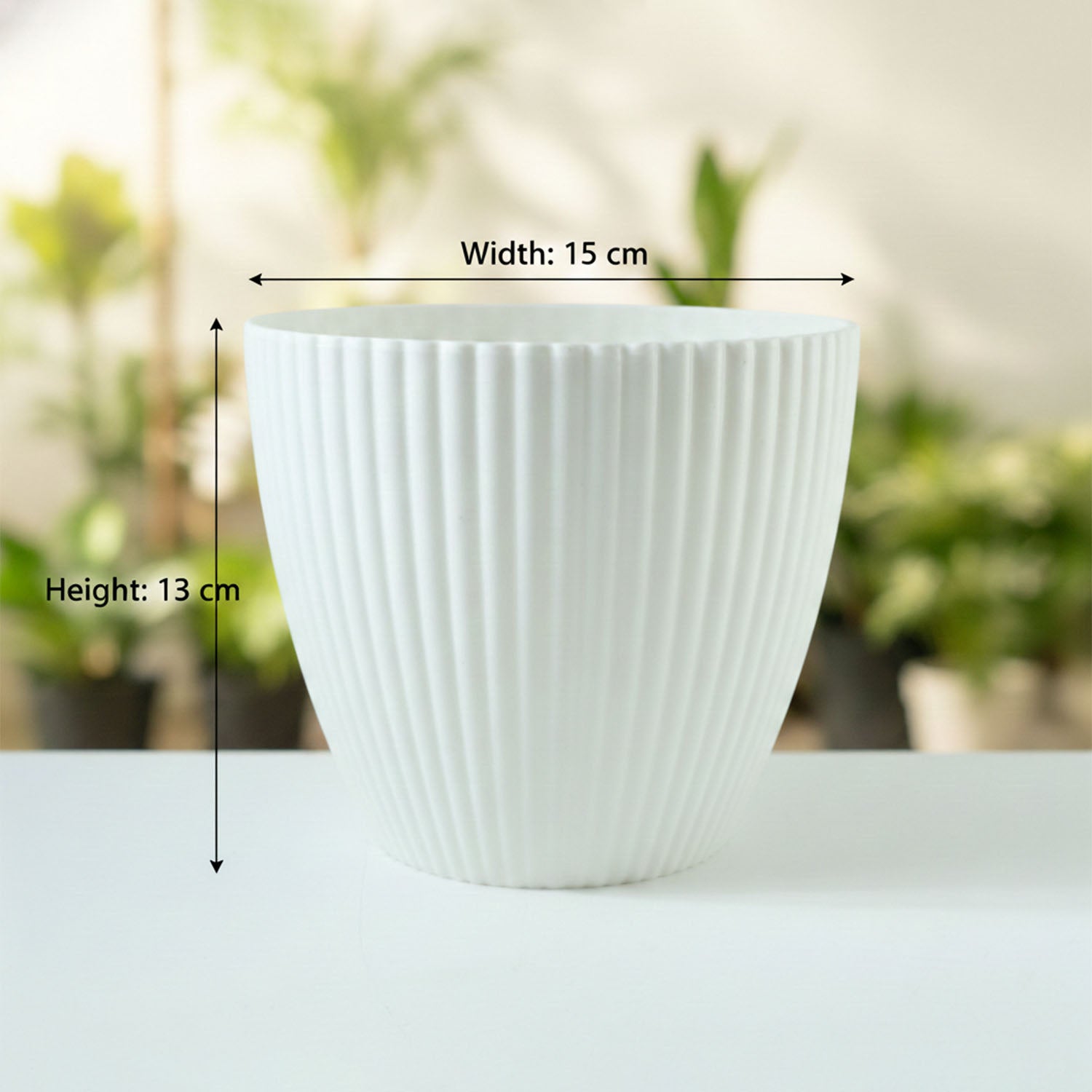 Size comparison of white ribbed flower pots for indoor gardening