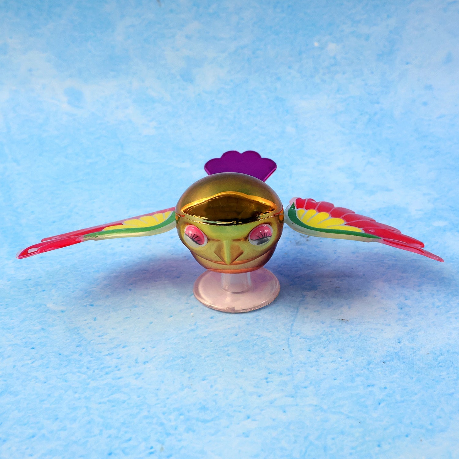 Side view of wind flying bird dashboard accessory showing wing detail