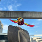 Close-up view of flying bird dashboard decoration with vibrant colors