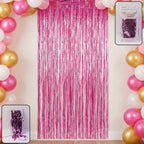 Shiny foil fringe curtain hanging from a doorway creating a metallic shimmer party backdrop.