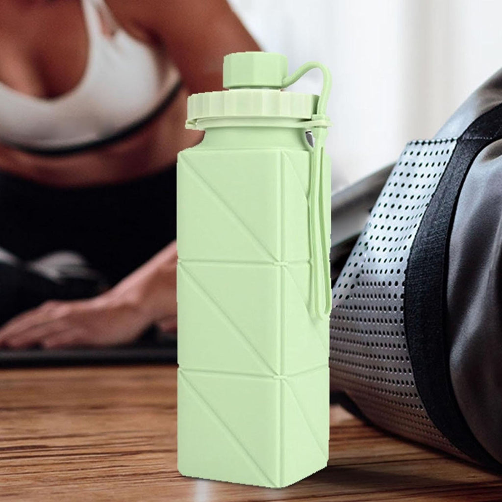 User showing collapsible foldable water bottle in use