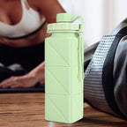 User showing collapsible foldable water bottle in use