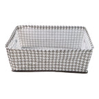 A minimalist-designed foldable canvas storage basket filled with soft linens, enhancing room aesthetics.
