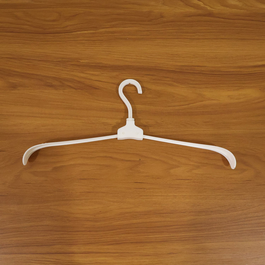 Plastic foldable garment hanger in use for organized closet