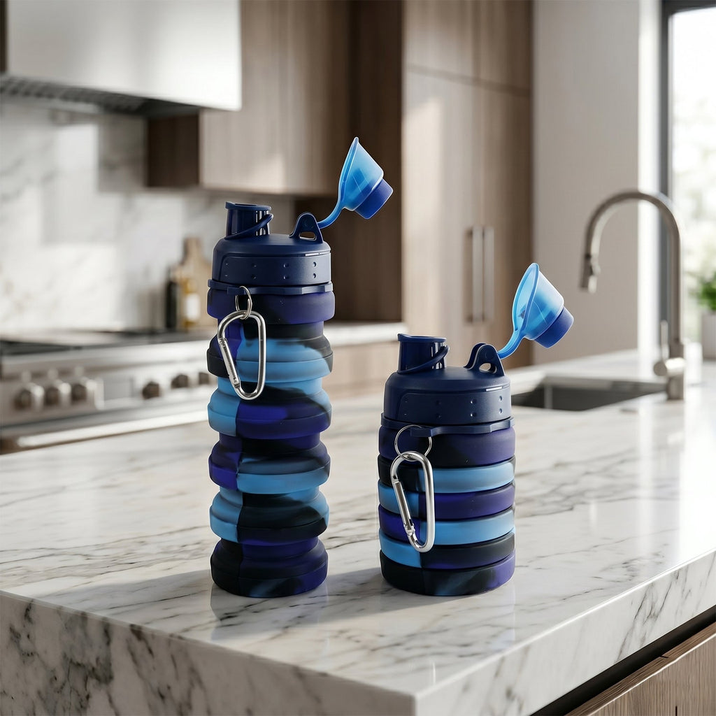 Folded collapsible water bottle placed beside a backpack for travel use