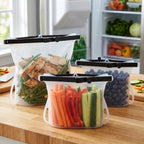 Transparent reusable silicone bags organized in a freezer drawer.