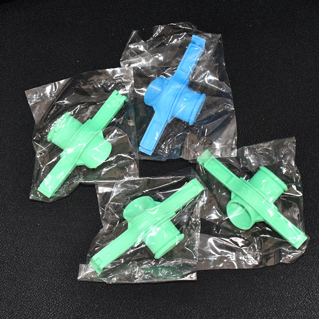 Multiple Food Pouch Sealer Clips in various colours on a kitchen counter.