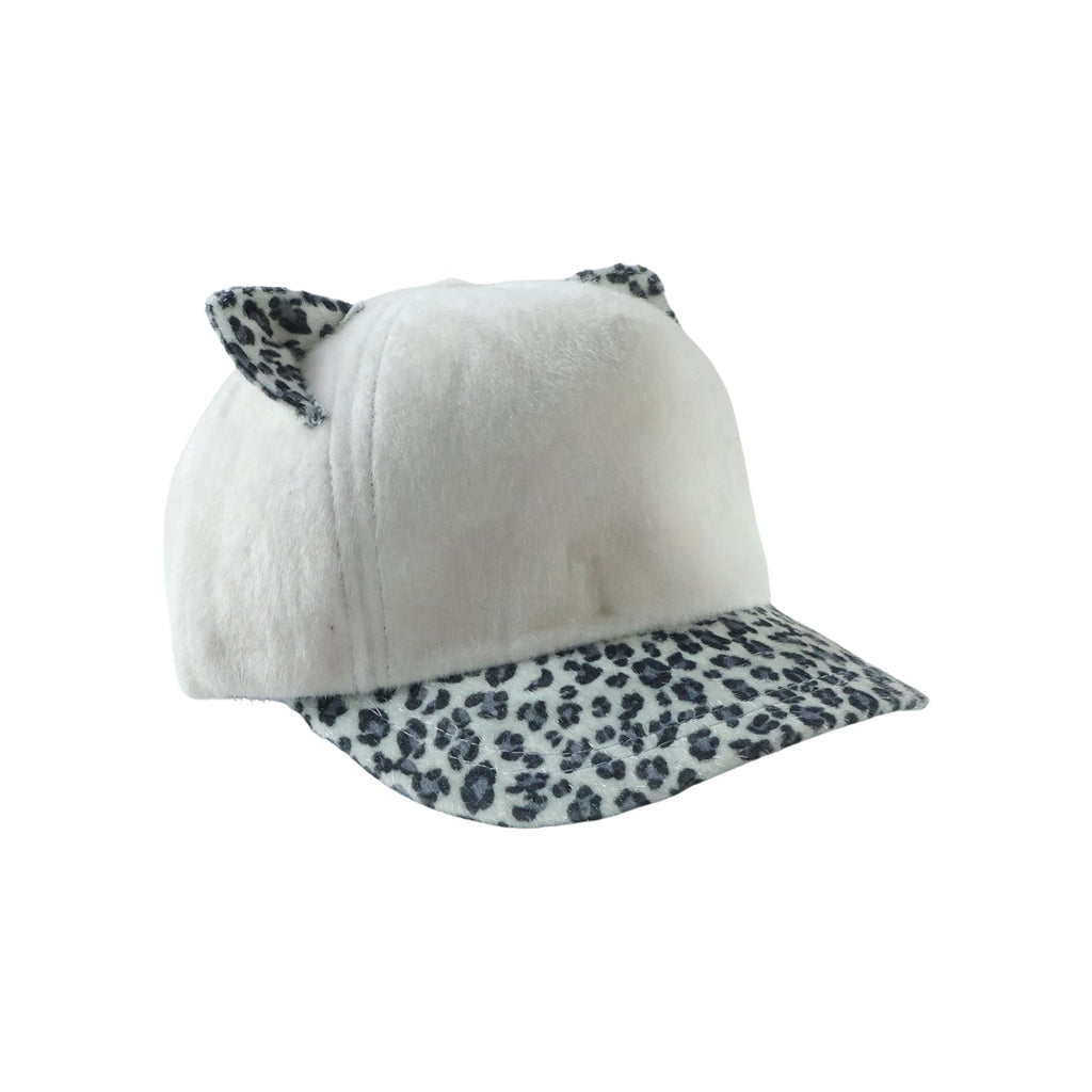 Winter fur cap styled on mannequin, playful winter accessory