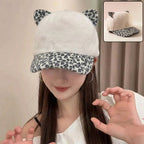 Front view of stylish cat ear fur cap with printed visor