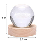 Hand holding the crystal ball lamp to show its compact size and portability.