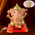 Solar-Powered Dancing Ganesha Idol with detailed gold accents on a decorative base