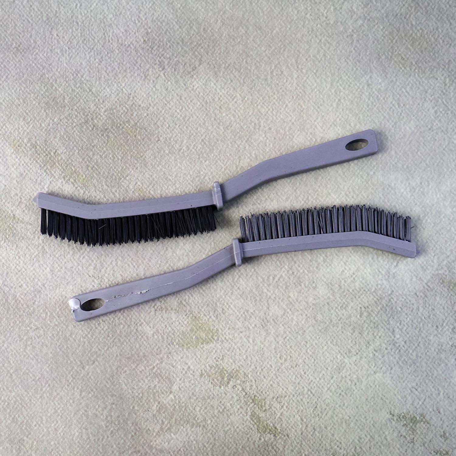 Angled head corner brush designed to clean narrow gaps and skirting