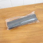 Black garbage bag roll in a retail setting, ready for purchase.