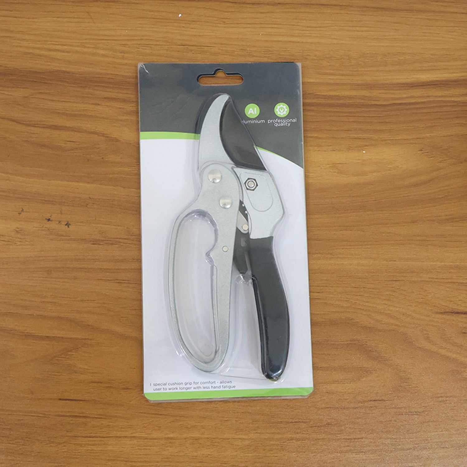 Indo Glow gardening pruning shears displayed next to fresh green foliage, ready for garden tasks.