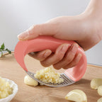 Detail of garlic press handle and stainless steel pressing surface