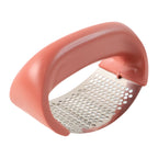 Garlic press crusher resting on kitchen counter
