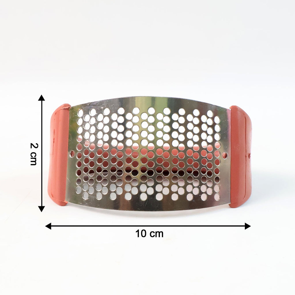 Close-up view of garlic being crushed by garlic press