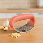 Angled view of premium curve garlic press for easy mincing