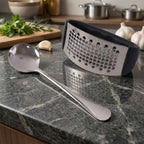 Close-up of perforated base for fine garlic crushing