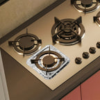 Gas stove with aluminium foil cover protecting burner area