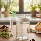 Kitchen oil dispenser bottle with green lid for controlled pouring