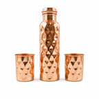 Detailed view of the sleek design and polished finish of the copper drinking glasses.