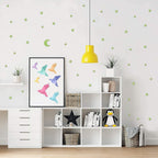 Fluorescent star and moon stickers glowing brightly at night, bringing the wonders of the cosmos indoors.