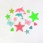 A cozy kids' bedroom beautifully decorated with luminous stars and moon decals, creating a peaceful ambiance.