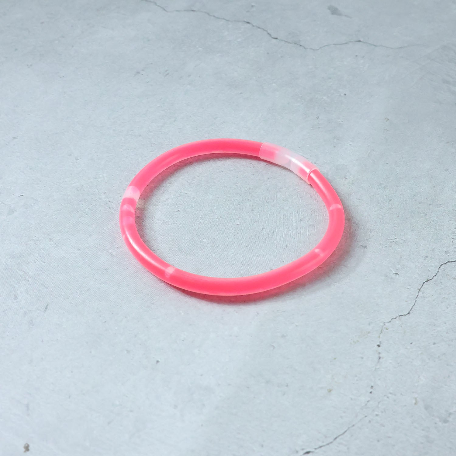 Person enjoying a concert while wearing a bright Glow LED Bracelet.