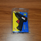 Hot melt glue gun placed upright on fold-out stand for safety and convenience