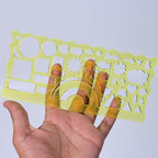 Clear green geometric template rulers for precise drawing and school projects.