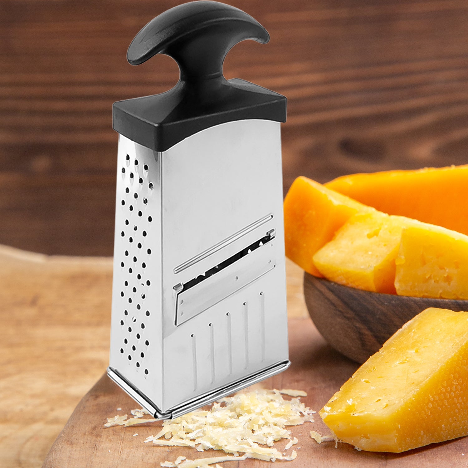 Compact stainless steel grater and slicer with non-slip handle base