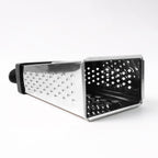 Fine and coarse grater surfaces of stainless steel 4-in-1 grater with handle