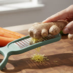 Compact kitchen vegetable peeler and grater for space-saving storage