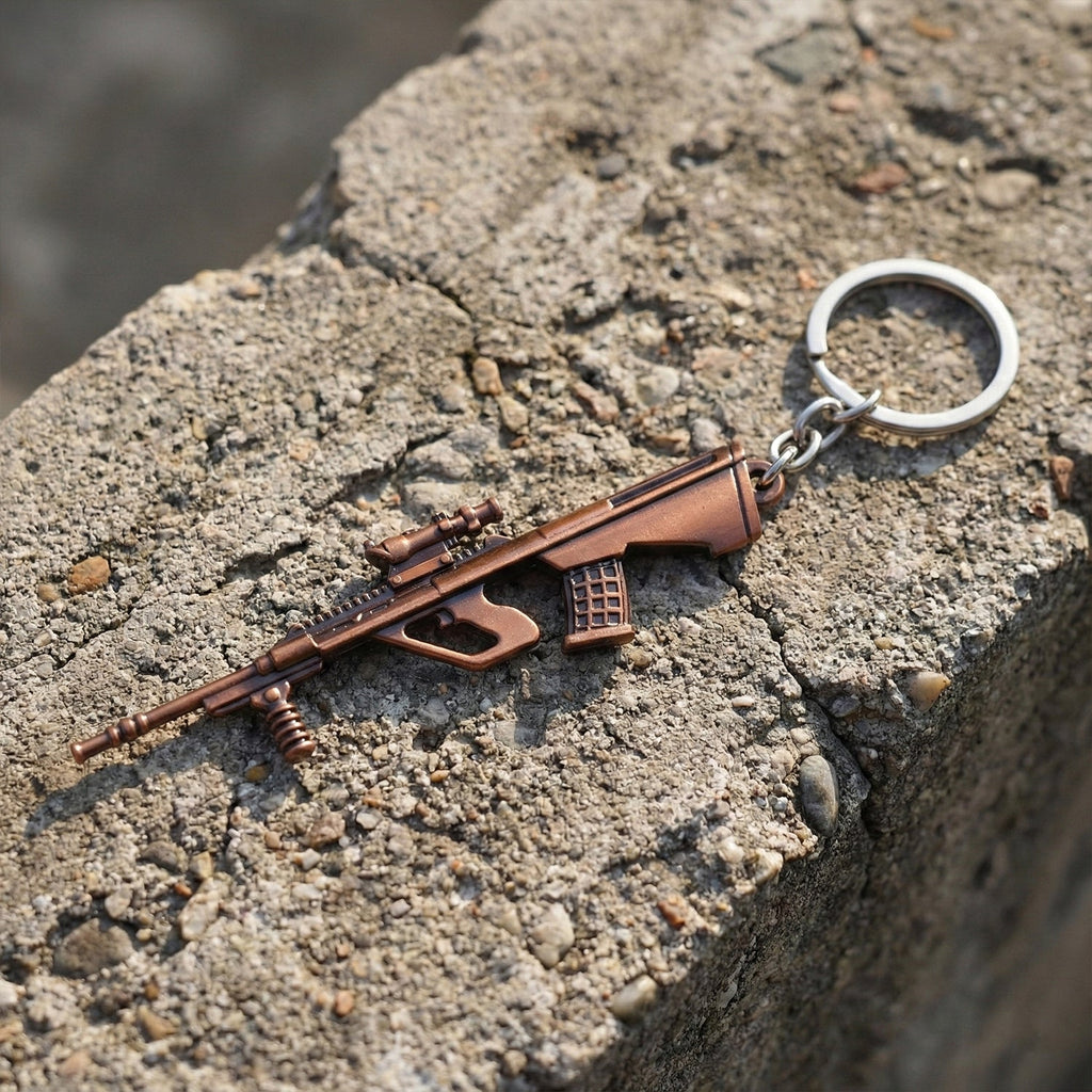Side view of metal gun-shaped keychain accessory