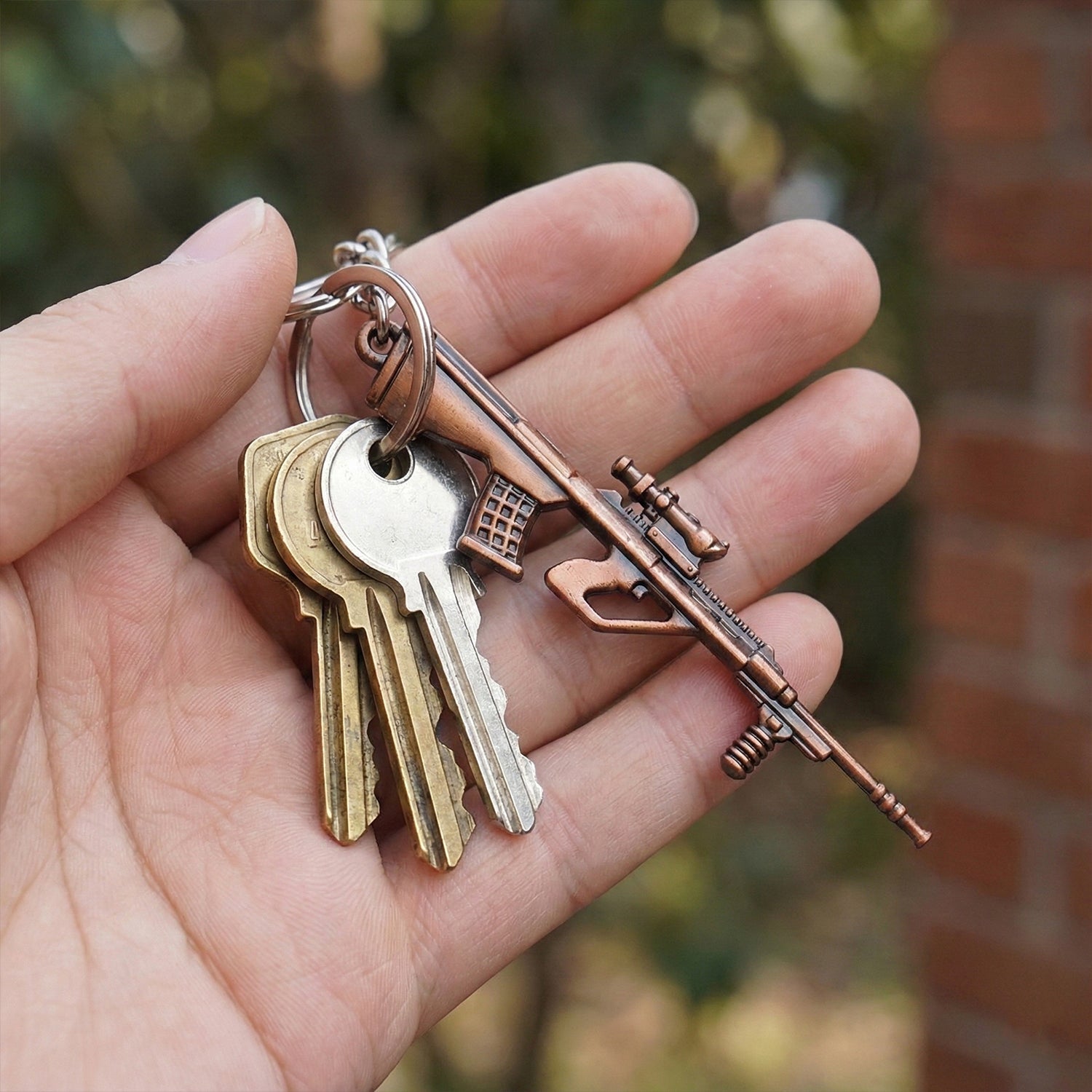 Top view of durable metal gun keychain with antique finish
